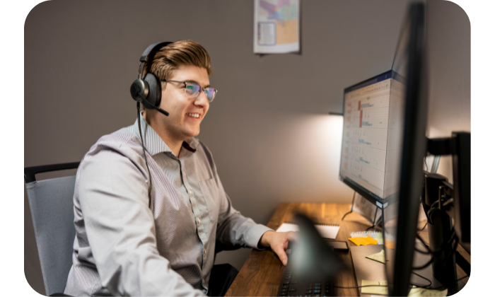 Yard Dawgs customer success manager smiles while talking on the phone with a client