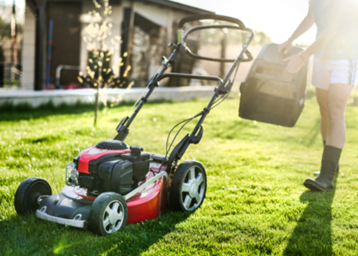 homeowner removes lawn mower bag from mower