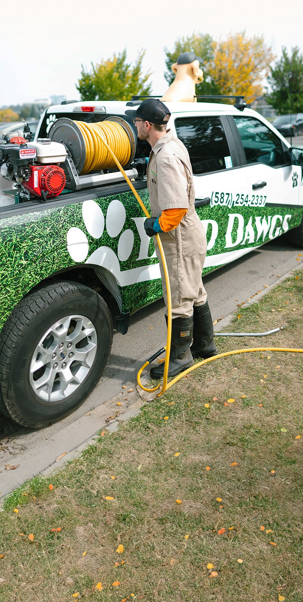 Lawn Specialist Unloading Hose From Truck